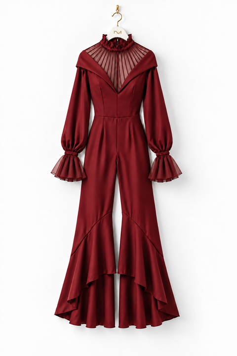 Front view of the VERA burgundy high-low jumpsuit by Modella featuring a sheer pleated high-neck yoke, fitted waist, long sleeves with sheer flared cuffs and dramatic flared legs