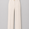 Front view of AURA ivory wide-leg tailored trousers featuring a high waist, front pleats and signature gold button by Modella