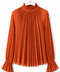 Front view of AURA orange pleated blouse by Modella featuring a ruffled high neckline, fine pleating and flared ruffle cuffs