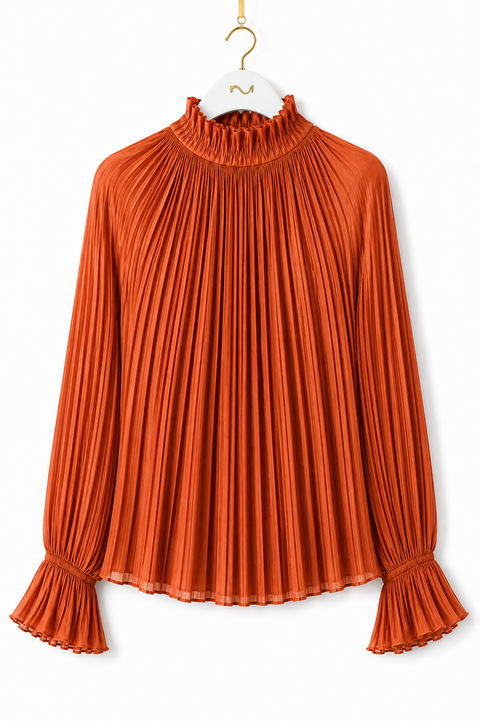 Front view of AURA orange pleated blouse by Modella featuring a ruffled high neckline, fine pleating and flared ruffle cuffs