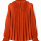 Back view of the orange pleated blouse from the AURA women’s ivory three-piece tailored suit by Modella with high ruffle collar and pleated silhouette