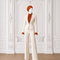 Front view of AURA women’s ivory three-piece tailored suit by Modella with orange pleated blouse and wide-leg trousers