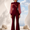 Front view of EVE burgundy jumpsuit by Modella with statement sleeves and flared leg silhouette