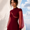 Three quarter view of EVE burgundy jumpsuit by Modella featuring sheer sleeves, sculpted tailoring and elegant modest eveningwear design