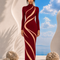LILIA burgundy evening dress by Modella featuring sculptural curved panel detailing, high neckline and elegant full length silhouette from the Lost Paradise collection