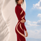 Side view of LILIA burgundy evening dress by Modella featuring elegant contouring and full length silhouette