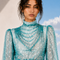 Close up view of MAYA draped blouse by Modella featuring printed chiffon, draped neckline and statement sleeves