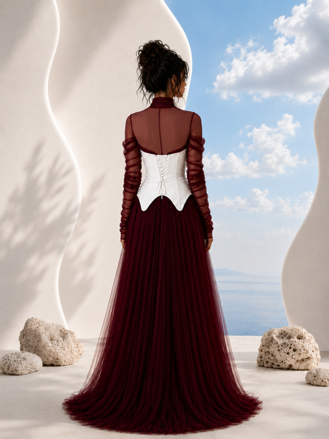 Back view of NYRA burgundy evening gown by Modella featuring layered tulle, structured bodice and elegant full length silhouette