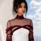 Close up view of NYRA burgundy evening gown by Modella featuring a fitted nude underlayer beneath soft illusion tulle and a structured ivory bodice