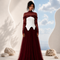NYRA burgundy evening gown by Modella featuring a structured ivory bodice, layered tulle skirt and modest sheer upper construction