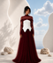 NYRA burgundy evening gown by Modella featuring a structured ivory bodice, layered tulle skirt and modest sheer upper construction
