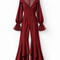 Front view of the VERA burgundy high-low jumpsuit by Modella featuring a sheer pleated high-neck yoke, fitted waist, long sleeves with sheer flared cuffs and dramatic flared legs