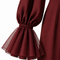 Close-up of the VERA burgundy jumpsuit by Modella featuring a sheer tulle flared cuff with gathered wrist detailing and long statement sleeve